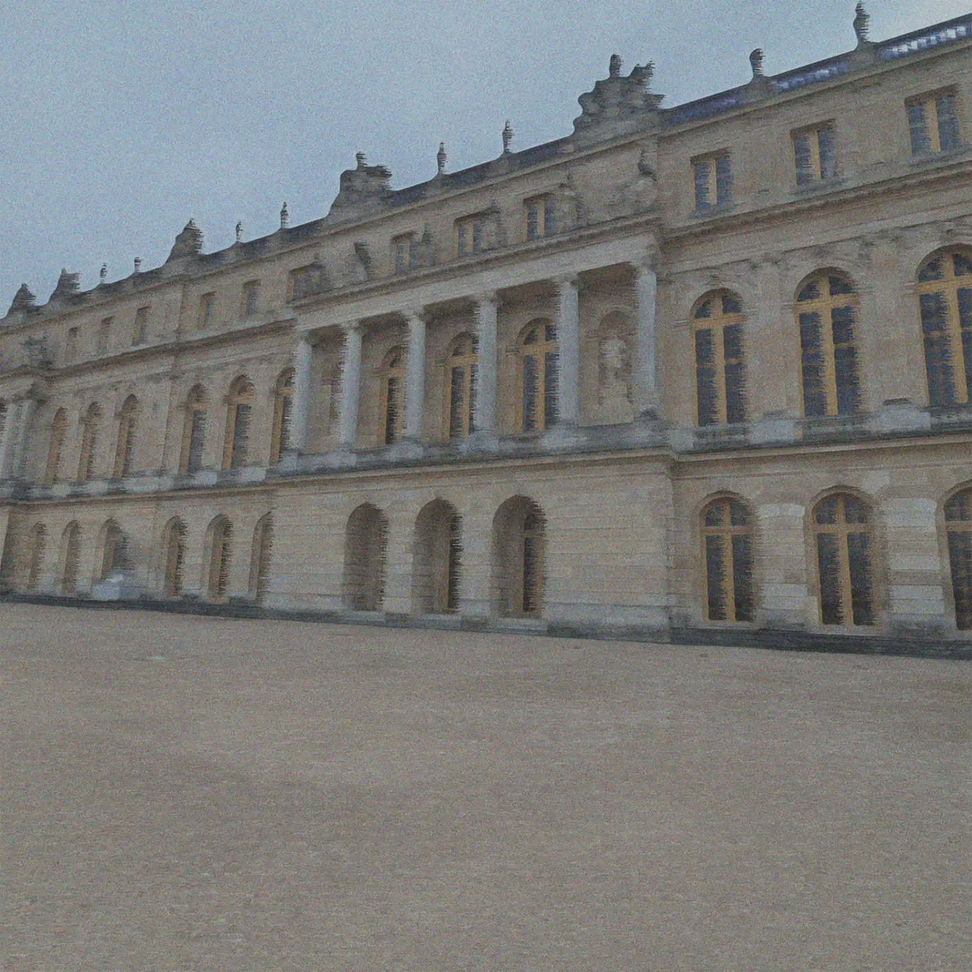 A stylized photo of the outside of the Palace of Versailles